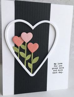 a heart shaped card with two pink flowers