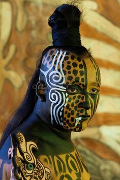 a woman with painted face and body art