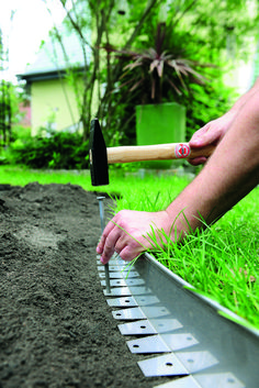 a person is digging in the ground with a garden shovel and trowel on it