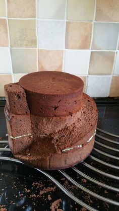 a chocolate cake sitting on top of a metal rack