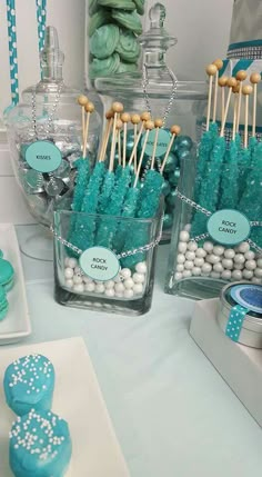 desserts and candies are displayed in glass containers