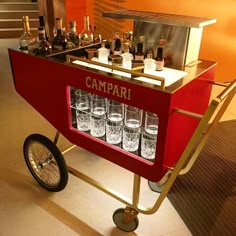 a cart filled with glasses sitting on top of a floor