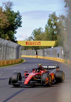 a red race car driving down the road