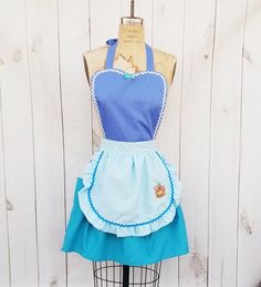 the apron dress is blue and has white trim