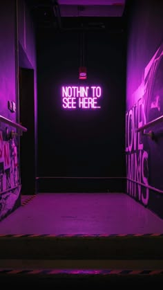 a purple neon sign that says nothing to see here in the middle of a dark room