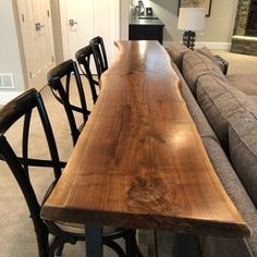 a long wooden table sitting in the middle of a living room