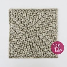 a close up of a knitted square on a white background with the words polka dot studio