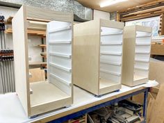 several shelves are being constructed in a workshop