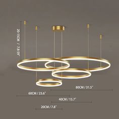 an image of a modern chandelier with three circles hanging from the ceiling and measurements