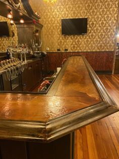 an empty bar with lots of wine glasses on it