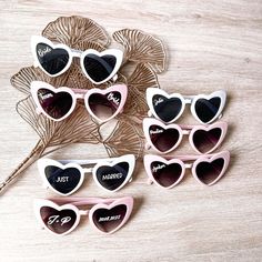 six pairs of heart shaped sunglasses with the word just married written on them, sitting next to each other