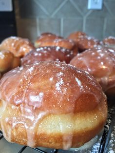 glazed donuts sitting on top of a cooling rack