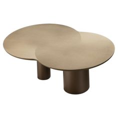 an oval table with two circular bases on it's sides, one in gold and the other in brown