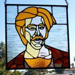 a stained glass portrait of a man hanging from the side of a building with palm trees in the background