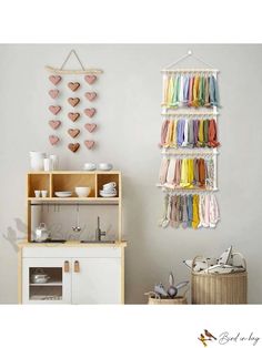 a wall hanging rack with hearts on it next to a white cabinet and counter top