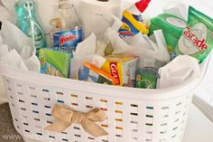 a white laundry basket filled with lots of cleaning products