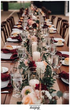 a long table is set with candles and flowers for a formal dinner or wedding reception