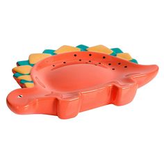 an orange and green alligator shaped dish on a white background