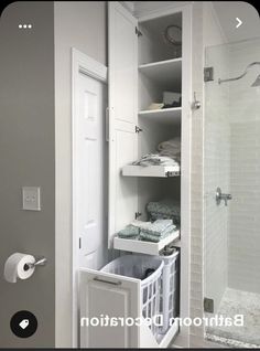 an open door to a bathroom with white cabinets