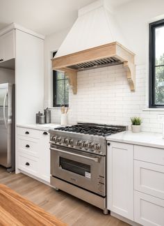 a stove top oven sitting inside of a kitchen