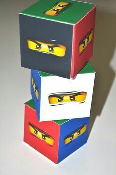 three lego boxes are stacked on top of each other with eyes painted on them,