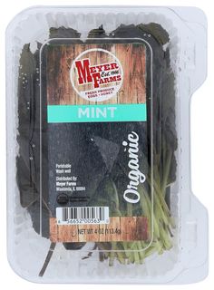 a package of green beans sitting on top of a plastic container filled with black beans