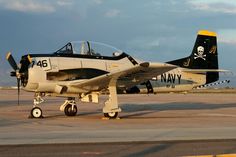 an old navy plane is parked on the tarmac with its wheels still in place