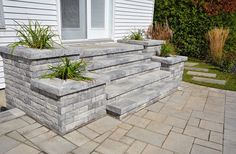 an outdoor patio with stone steps and planters