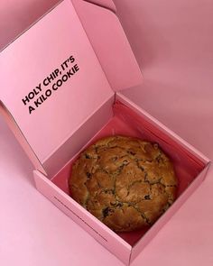 a cookie in a pink box on a pink surface