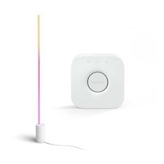 an electronic device with a colorful light coming out of it's back end, and a white object next to it