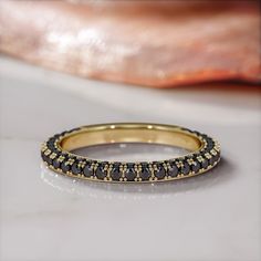 a black and gold ring sitting on top of a table