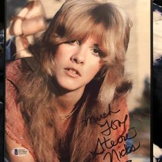 an autographed photo of a woman with long hair