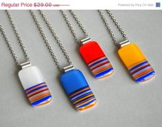 four necklaces with different designs on them