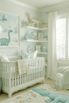 a baby's room decorated in blue and white with dinosaurs on the wall, crib, rocking chair, and bookshelf