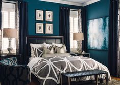 a bedroom with blue walls and white curtains