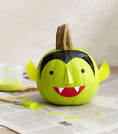 a paper mache pumpkin decorated to look like a monster