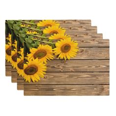 sunflowers on wooden planks with green leaves