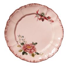 a pink plate with flowers painted on it