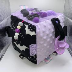 a purple and black bag with mickey mouse on it