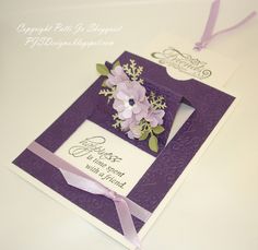 a purple card with flowers on it and a ribbon around the edge that says congratulations