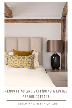 a bedroom with a bed, nightstand and lamp next to the headboard is shown