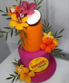 an orange and pink cake with flowers on top