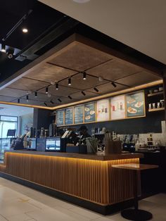 the interior of a restaurant with menus on the wall and lights hanging from the ceiling