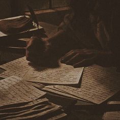 a person sitting at a table with lots of papers