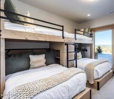 two bunk beds are next to each other in the room with sliding glass doors leading outside