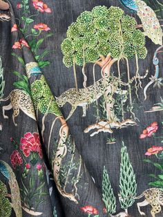 the fabric has animals and plants on it