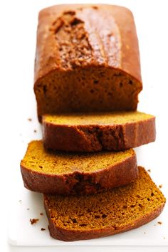 sliced loaf of pumpkin bread sitting on top of a white cutting board