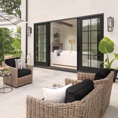 an outdoor living room with wicker furniture