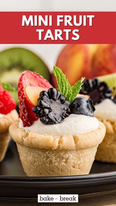 mini fruit tarts on a black plate