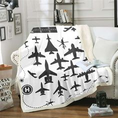 an airplane themed blanket is on the couch